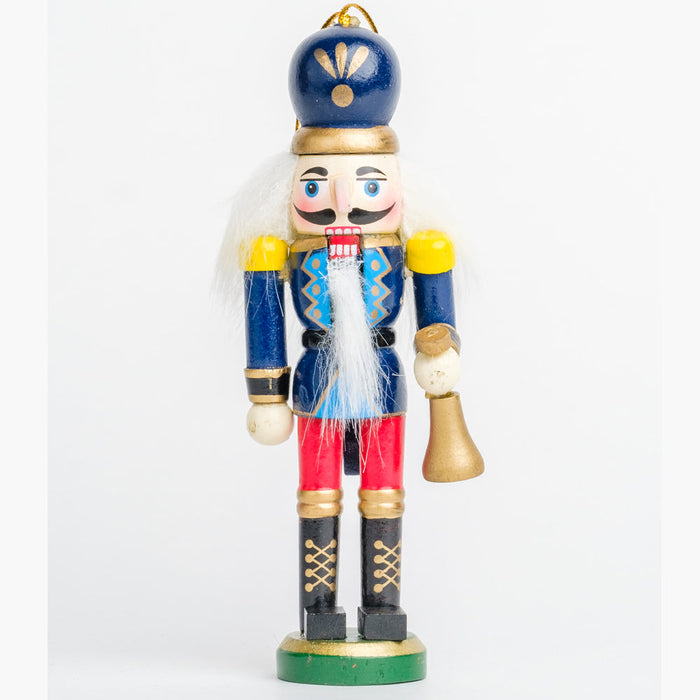 a nutcracker ornament holding a gold bell, wearing a blue and red uniform with a rounded blue and gold hat