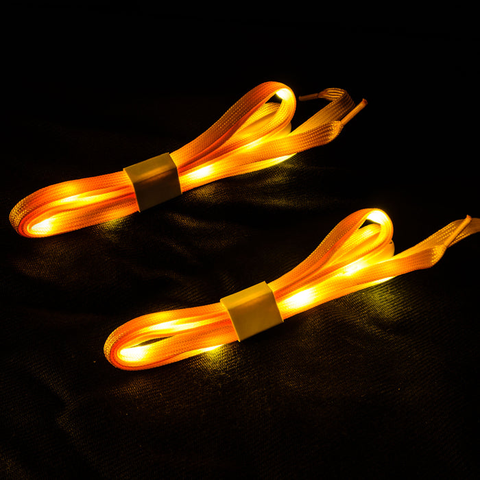 An upclose view of the yellow shoelaces lit up with yellow LED lights