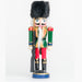 a nutcracker ornament holding a black and gold rifle, wearing a green, gold, and red uniform with a black fur hat