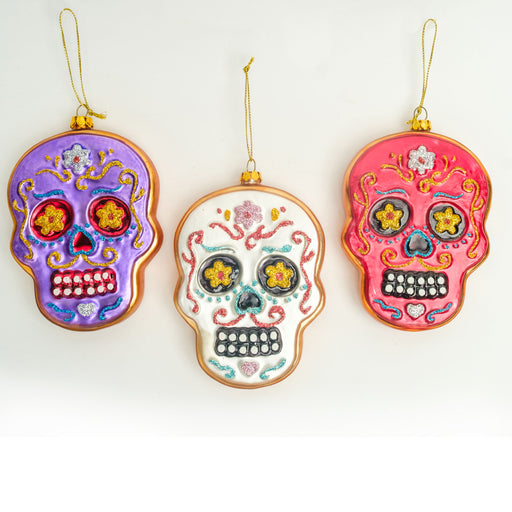 3 sugar skull ornaments with glitter accents shown together