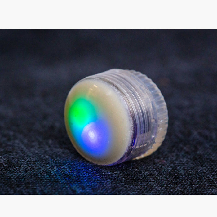 an upclose view of the LED button light lit up with the colors green and blue.