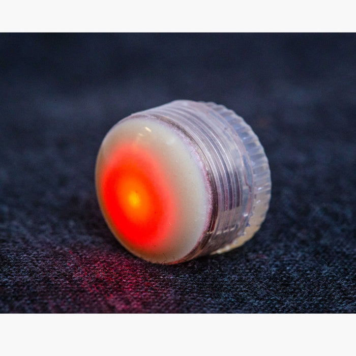 an upclose view of the LED button light lit up with the color red.