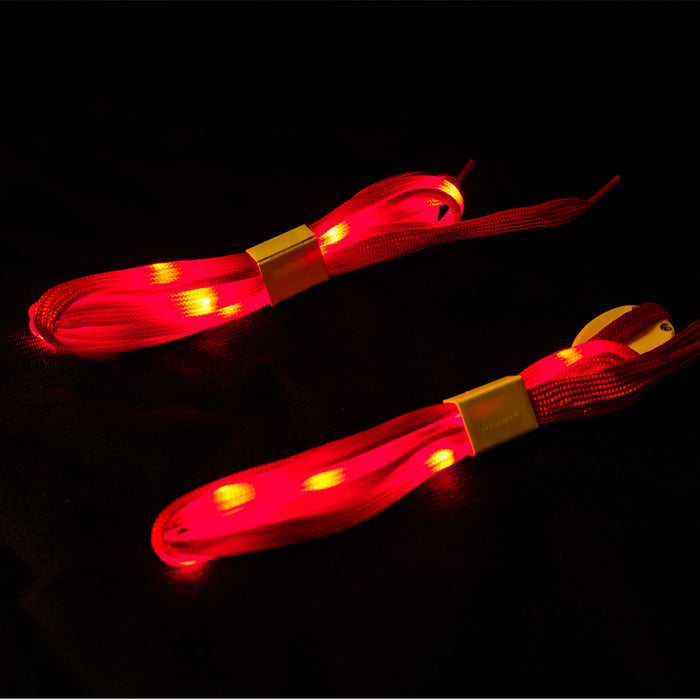 An upclose view of the red shoelaces lit up with red LED lights