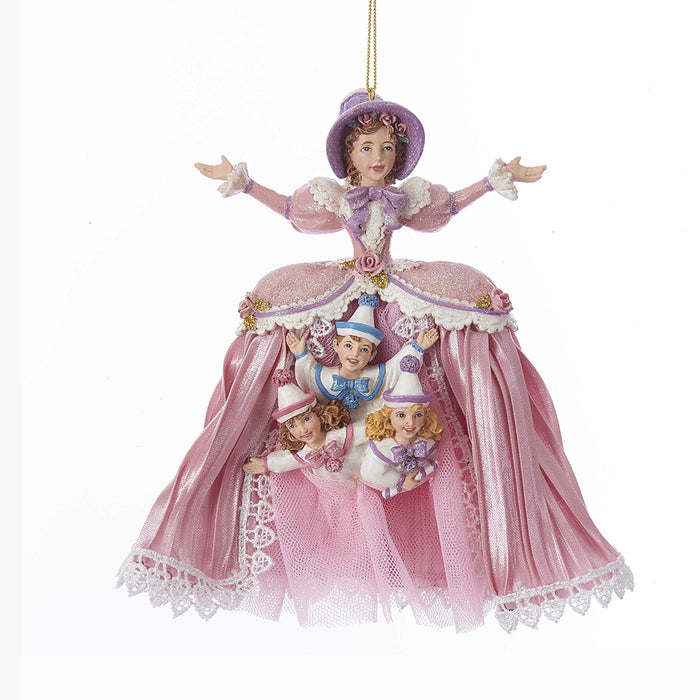 a mother Ginger ornament with a pink gown & 3 children sticking out of her skirt wearing white outfits & colorful bows & hats