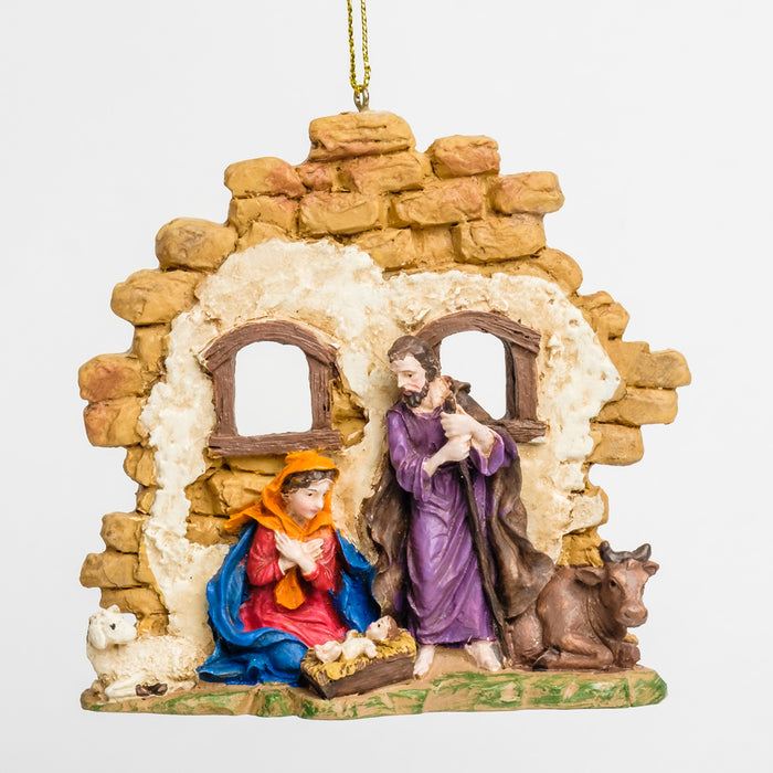 a nativity scene ornament with Mary & Joseph near a barn, looking over baby Jesus in a manger, surrounded by a cow & a sheep