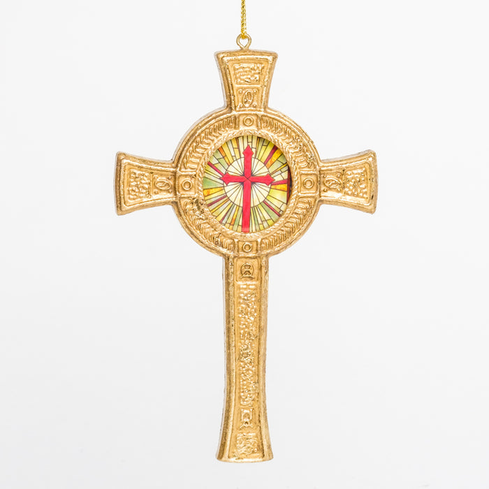 a detailed gold cross ornament with a circular warm-tone mosaic design in the center with a red cross