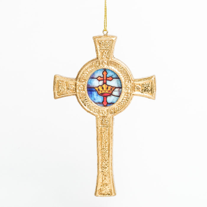 a detailed gold cross ornament with a circular blue stained-glass design in the center with an orange cross and a gold crown