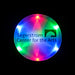 An upclose view of a lit LED circular pendant necklace with multicolored lights & the Segerstrom Center for the Arts logo