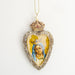 A gold sacred heart ornament with glitter accents & a gold crown on top, & a gold & blue mosaic of the Madonna in the center
