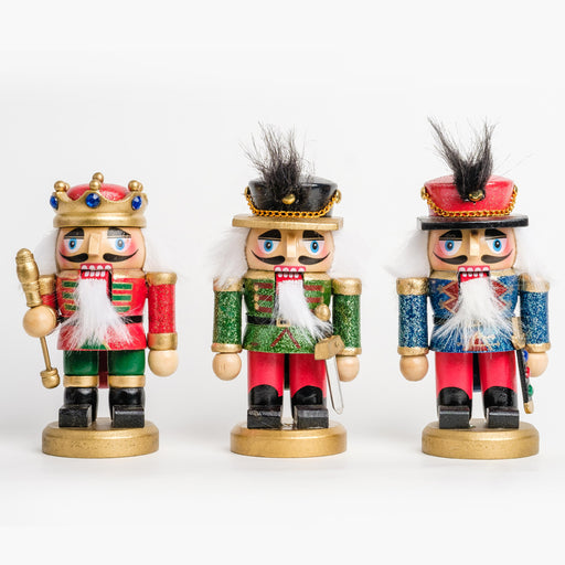 A short king nutcracker and two short soldier nutcrackers shown together