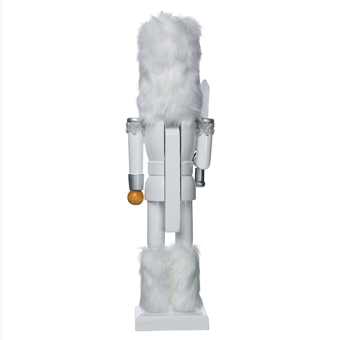 the back of the nutcracker wearing a white outfit with a white fur hat and boots, displaying the white nutcracker handle