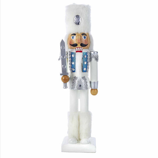 a nutcracker wearing a white outfit with silver & blue glitter accents with a white fur hat and boots, holding a silver sword