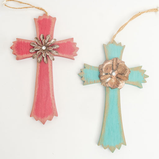 2 wooden cross ornaments shown together in a faded blue or red with a bronze flower & a silver gemstone in the center of each